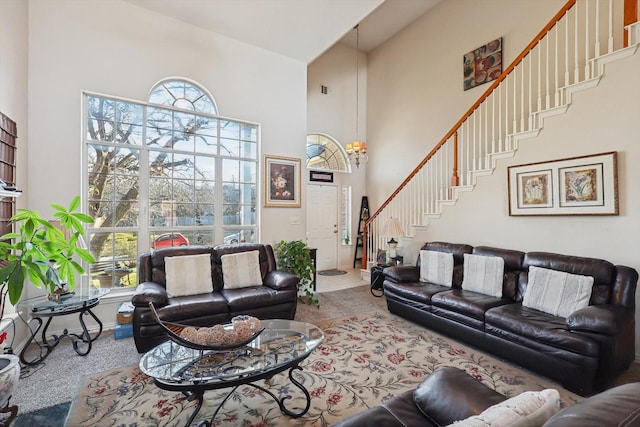 carpeted living room with a towering ceiling and plenty of natural light