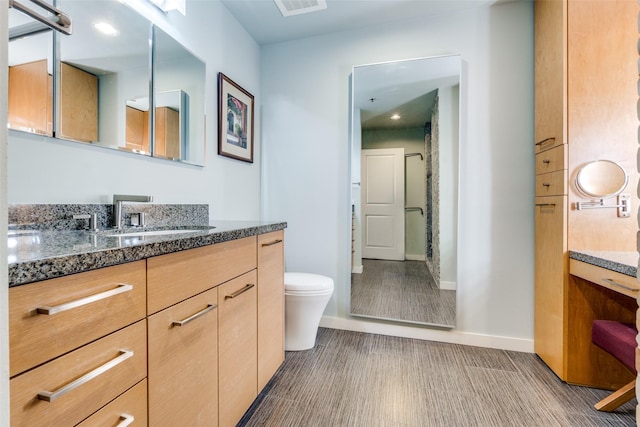 bathroom with vanity, hardwood / wood-style floors, and toilet