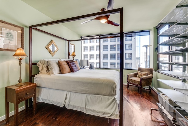 bedroom featuring multiple windows, dark wood-type flooring, and ceiling fan