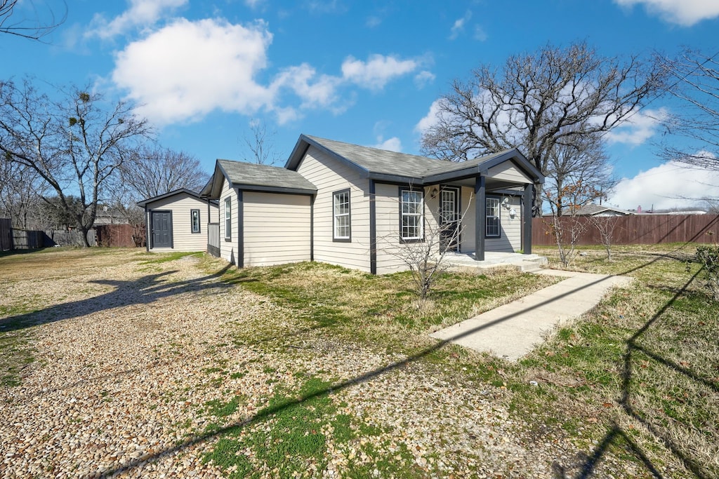 view of front of property with covered porch and a front yard