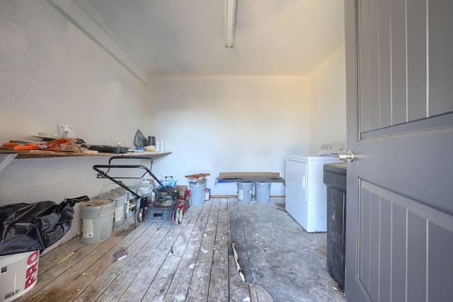 clothes washing area with washer / dryer and hardwood / wood-style flooring