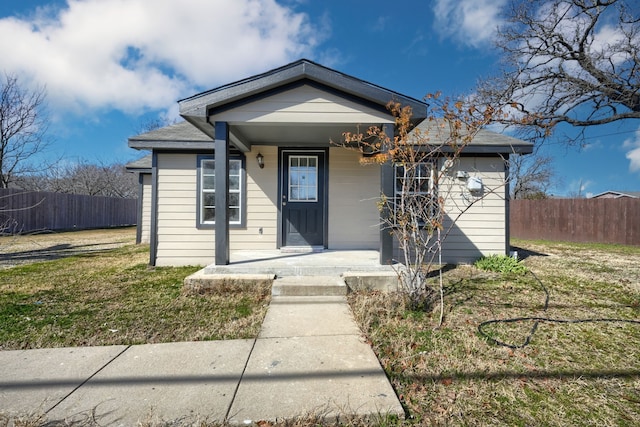 bungalow-style house with covered porch and a front yard