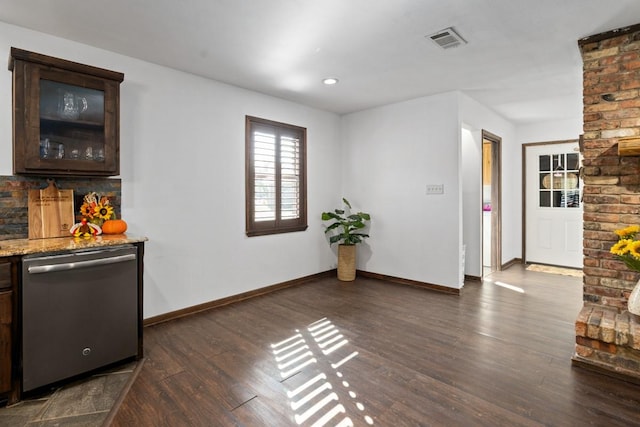 interior space featuring light stone counters, dark brown cabinets, dark hardwood / wood-style floors, and dishwasher