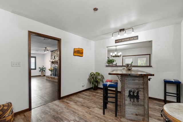 dining space featuring an inviting chandelier, wood-type flooring, and track lighting