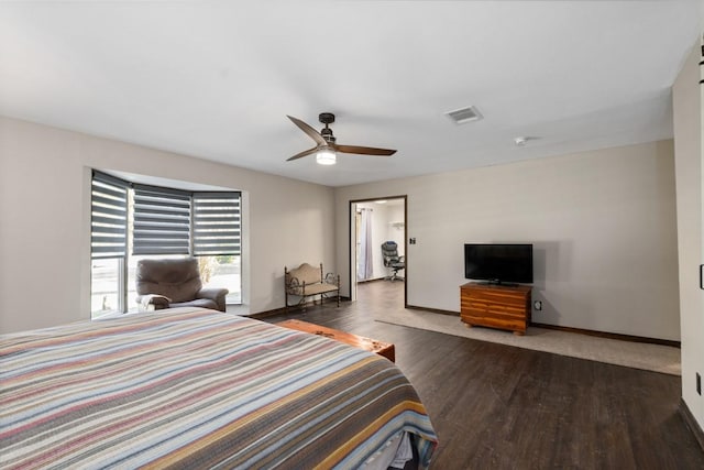 bedroom with ceiling fan and dark hardwood / wood-style floors