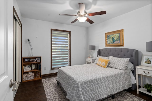 bedroom featuring dark wood-type flooring, a closet, and ceiling fan