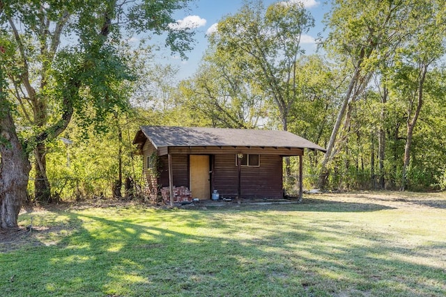 view of outbuilding featuring a yard