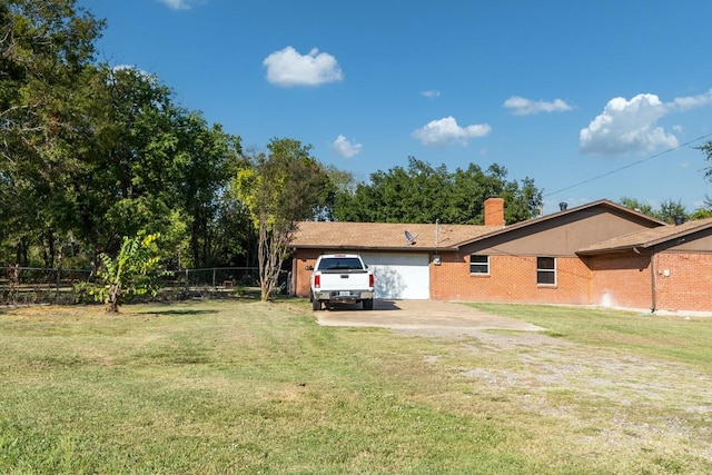 exterior space with a garage and a lawn