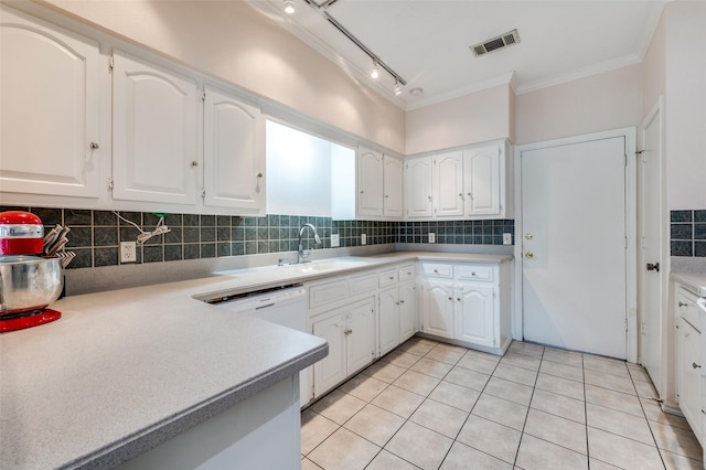 kitchen with tasteful backsplash, white cabinetry, and sink