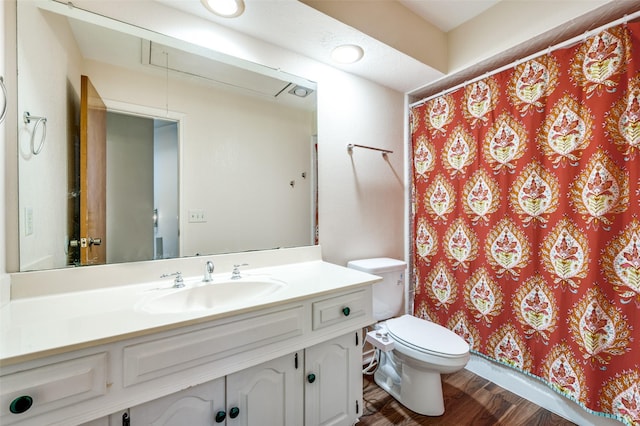 bathroom featuring hardwood / wood-style flooring, vanity, and toilet