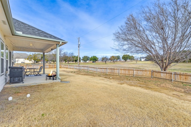 view of yard featuring an outdoor fire pit and a patio area