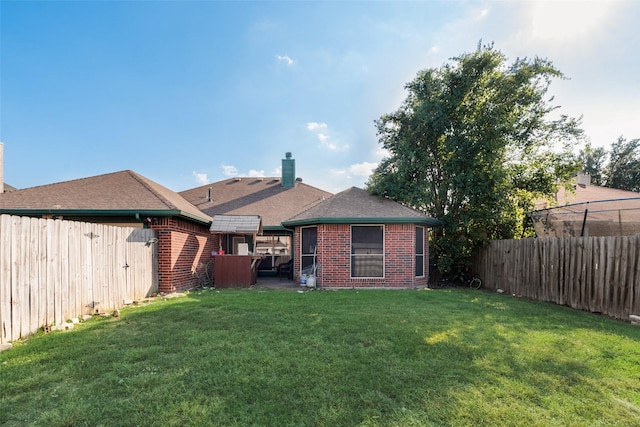 back of house with a yard