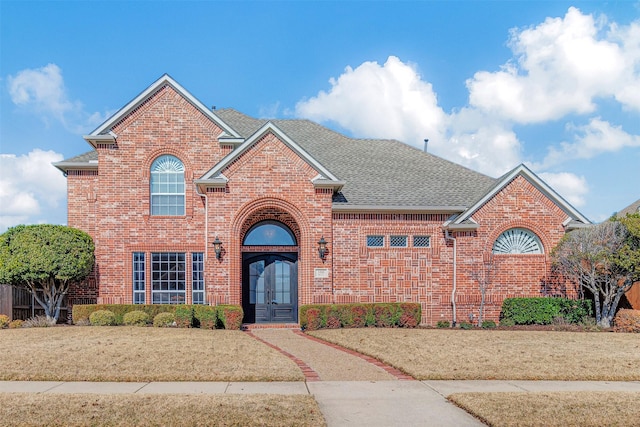 view of front property featuring french doors and a front yard