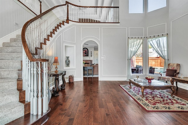 foyer entrance featuring dark hardwood / wood-style floors and a high ceiling