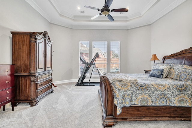 bedroom featuring a raised ceiling, crown molding, and light carpet