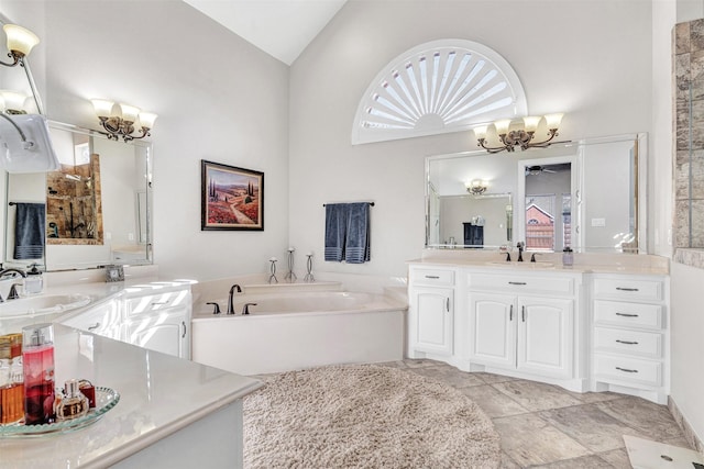 bathroom featuring lofted ceiling, vanity, a bathtub, and ceiling fan with notable chandelier