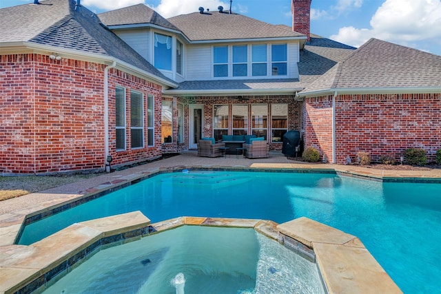 view of pool with an in ground hot tub, outdoor lounge area, and a patio