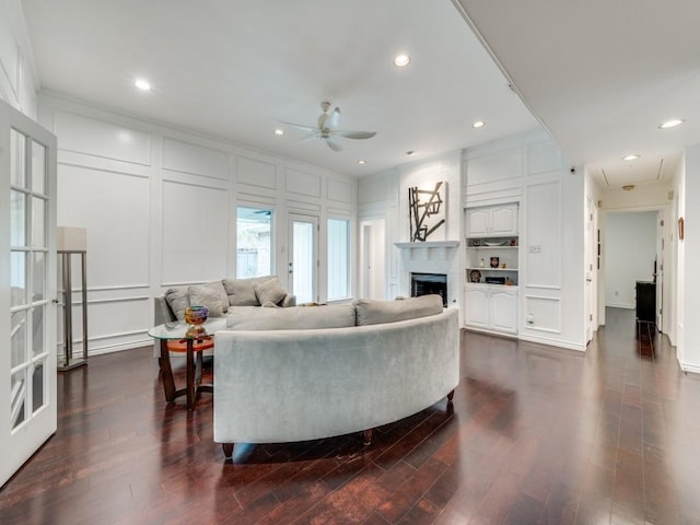 living room featuring crown molding, ceiling fan, and dark hardwood / wood-style flooring