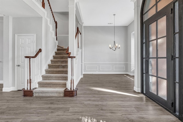 foyer featuring dark hardwood / wood-style floors and a chandelier