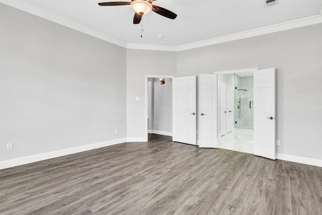 unfurnished bedroom with ceiling fan, ensuite bath, ornamental molding, and hardwood / wood-style floors