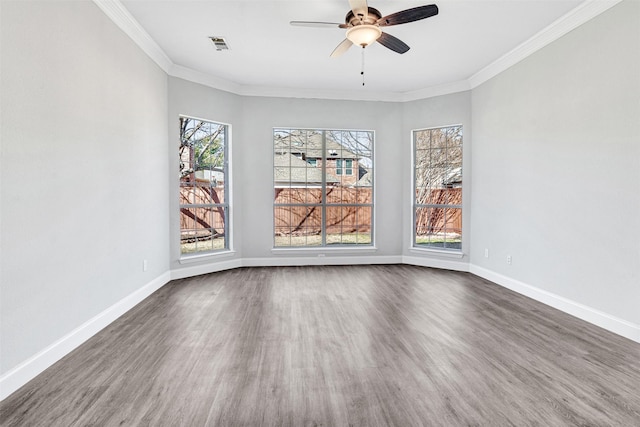 unfurnished dining area featuring dark wood-type flooring, ceiling fan, a healthy amount of sunlight, and crown molding