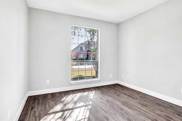 unfurnished room with hardwood / wood-style flooring