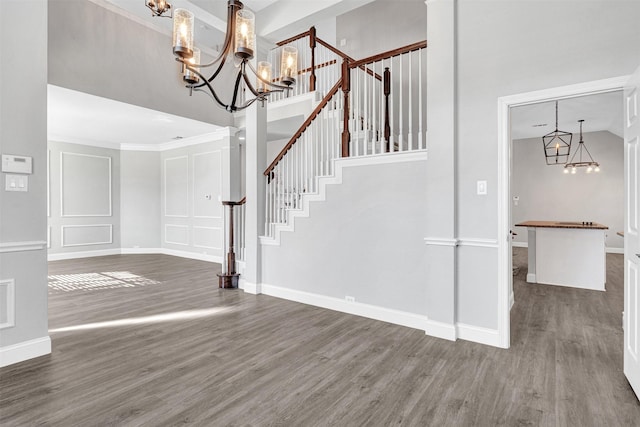 entrance foyer with an inviting chandelier, dark wood-type flooring, and a high ceiling