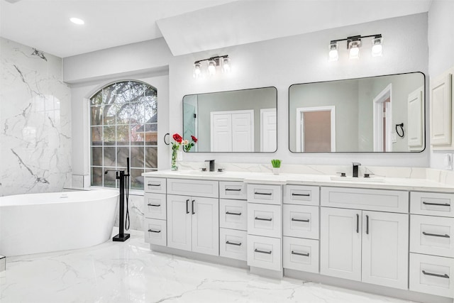 bathroom with a bathing tub and vanity