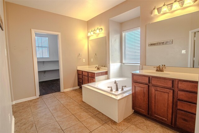 bathroom featuring vanity, tile patterned flooring, and a tub