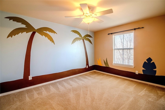 carpeted empty room featuring ceiling fan