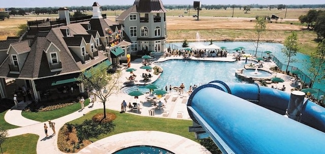 view of swimming pool with a rural view