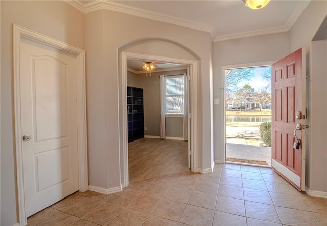 entrance foyer featuring ornamental molding and light tile patterned floors