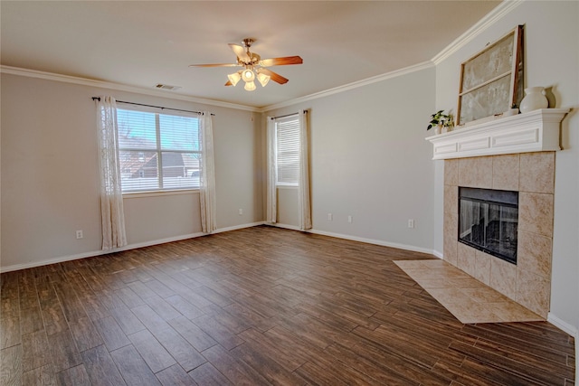 unfurnished living room featuring crown molding, ceiling fan, dark hardwood / wood-style floors, and a tiled fireplace