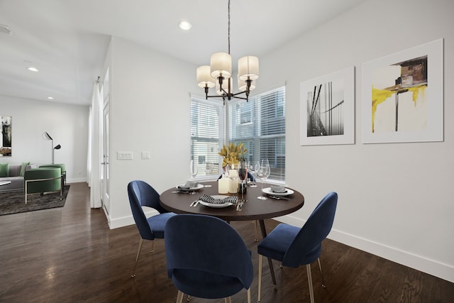 dining room with a notable chandelier and dark hardwood / wood-style flooring