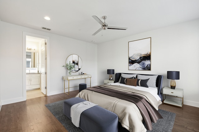 bedroom featuring ceiling fan, ensuite bathroom, and dark hardwood / wood-style flooring