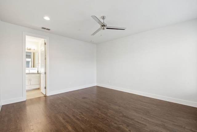 empty room with dark hardwood / wood-style flooring and ceiling fan