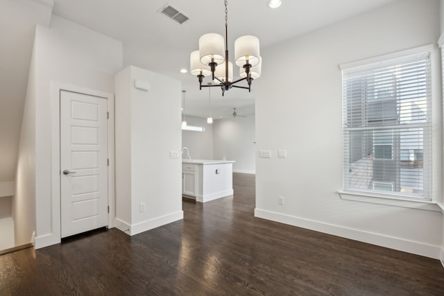 interior space with dark hardwood / wood-style flooring and ceiling fan with notable chandelier