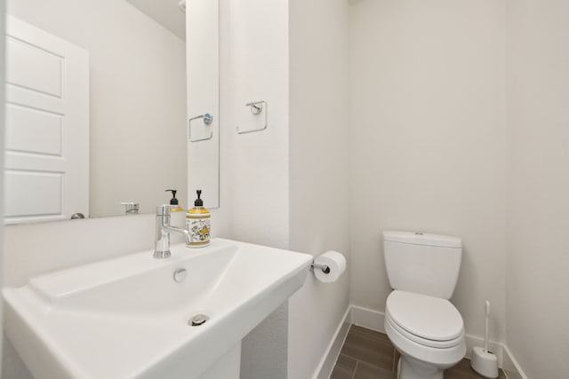 bathroom featuring sink, hardwood / wood-style flooring, and toilet