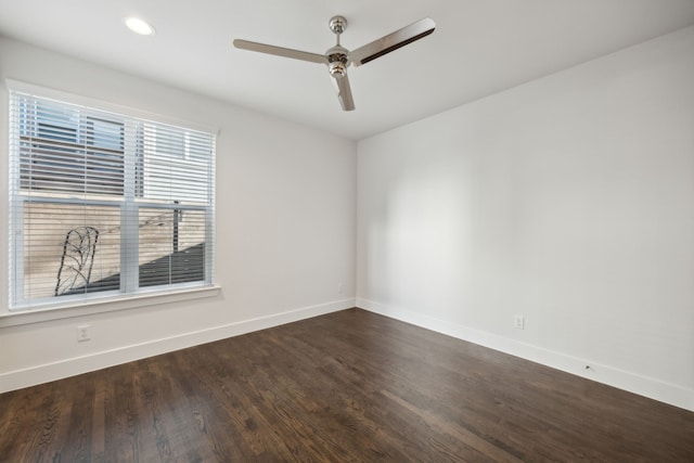 spare room featuring dark hardwood / wood-style floors and ceiling fan