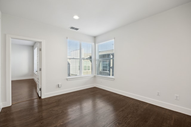 empty room with dark wood-type flooring