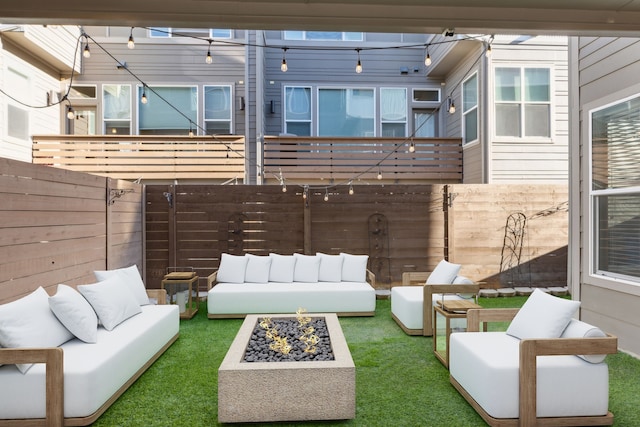 exterior space featuring an outdoor living space with a fire pit