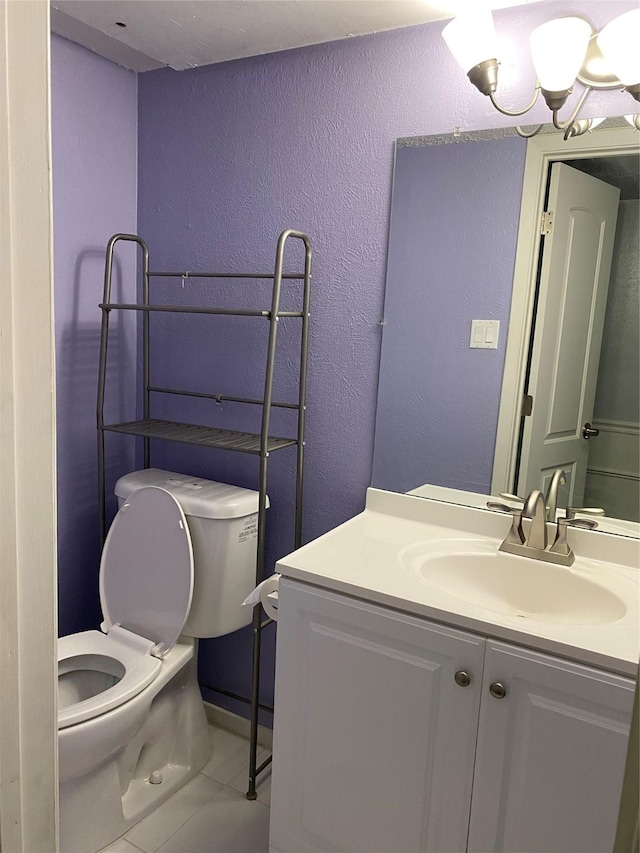 bathroom with tile patterned floors, vanity, and toilet