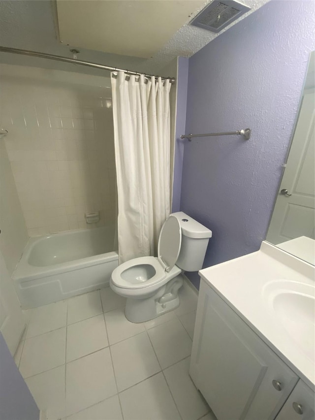 full bathroom with tile patterned flooring, toilet, vanity, and shower / bath combo with shower curtain