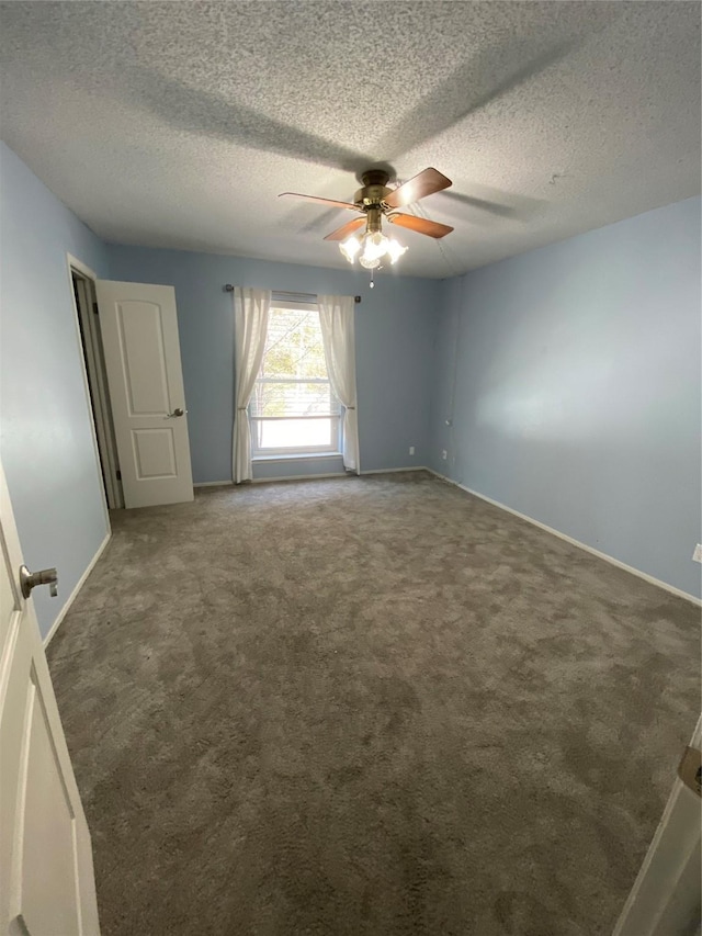 carpeted spare room featuring a textured ceiling and ceiling fan