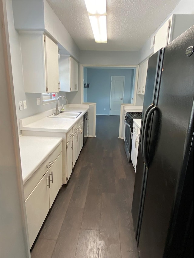 kitchen featuring white cabinetry, sink, dark hardwood / wood-style flooring, and black appliances