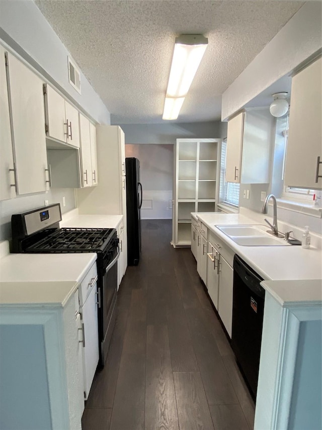 kitchen featuring sink, black appliances, a textured ceiling, dark hardwood / wood-style flooring, and white cabinets