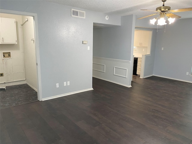 unfurnished living room featuring dark hardwood / wood-style flooring, ceiling fan, and a textured ceiling