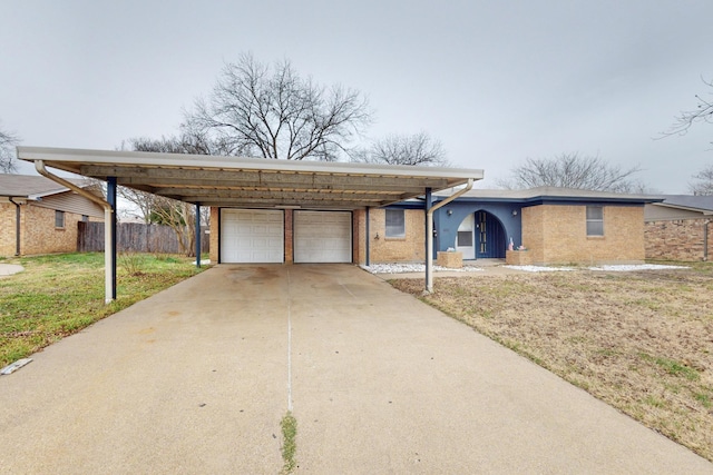 single story home featuring a garage, a front yard, and a carport