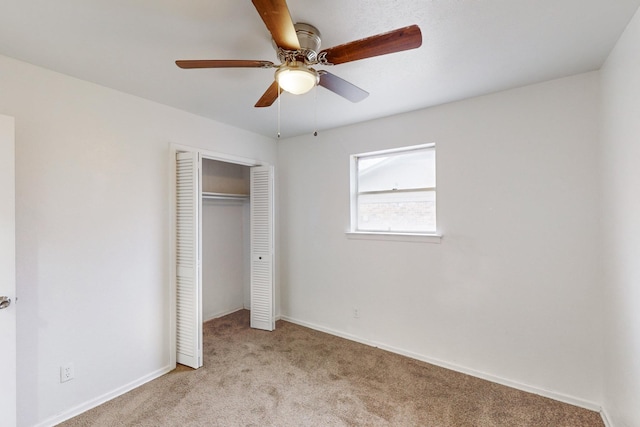 unfurnished bedroom featuring ceiling fan, light colored carpet, and a closet