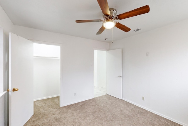 empty room featuring light colored carpet and ceiling fan